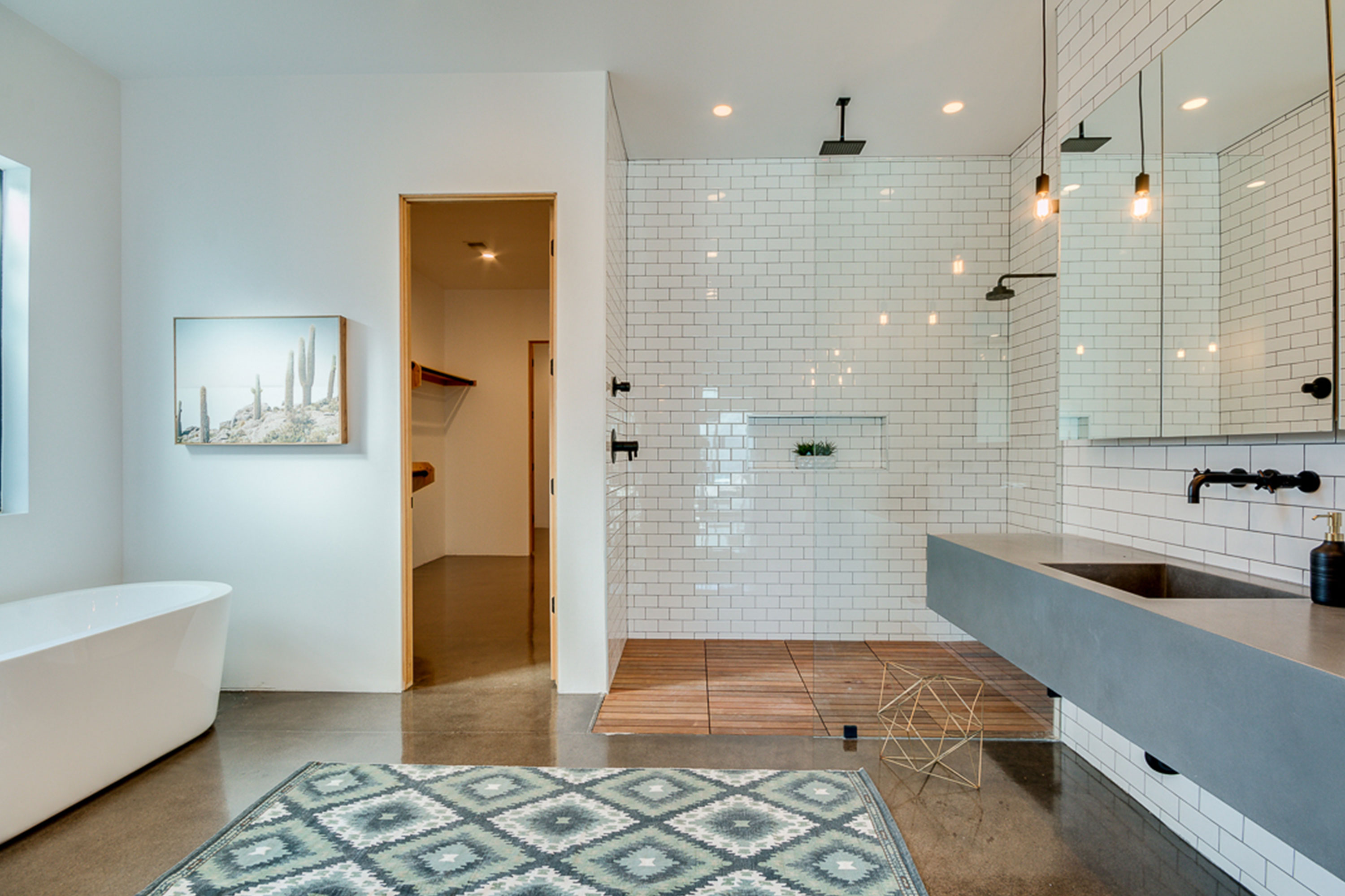 Master bathroom with polished concrete floors, his and hers concrete master vanities in the Coronado Historic District