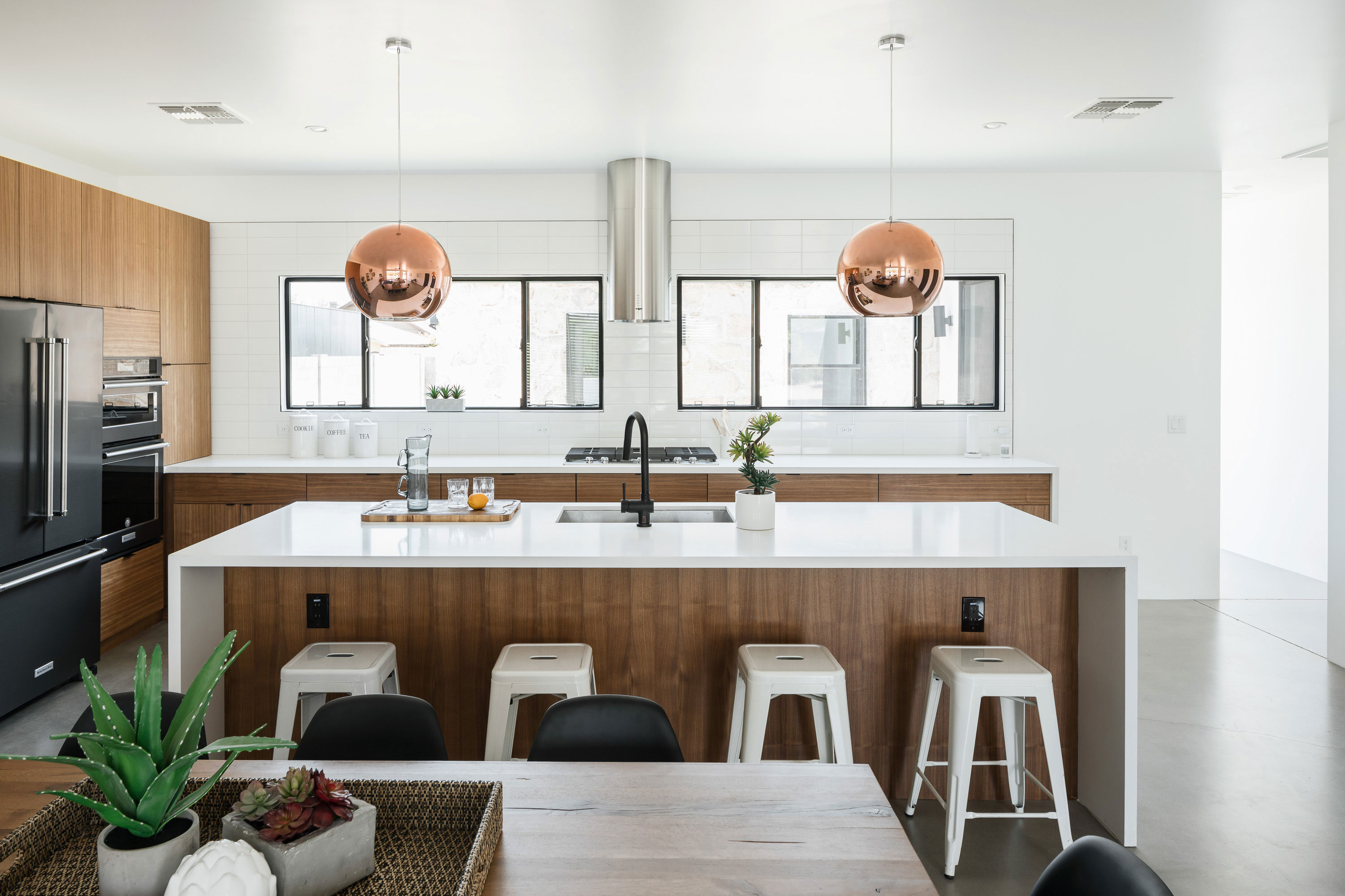 Modern home features all custom American Walnut cabinets and White Quartz counter-tops in Phoenix, AZ