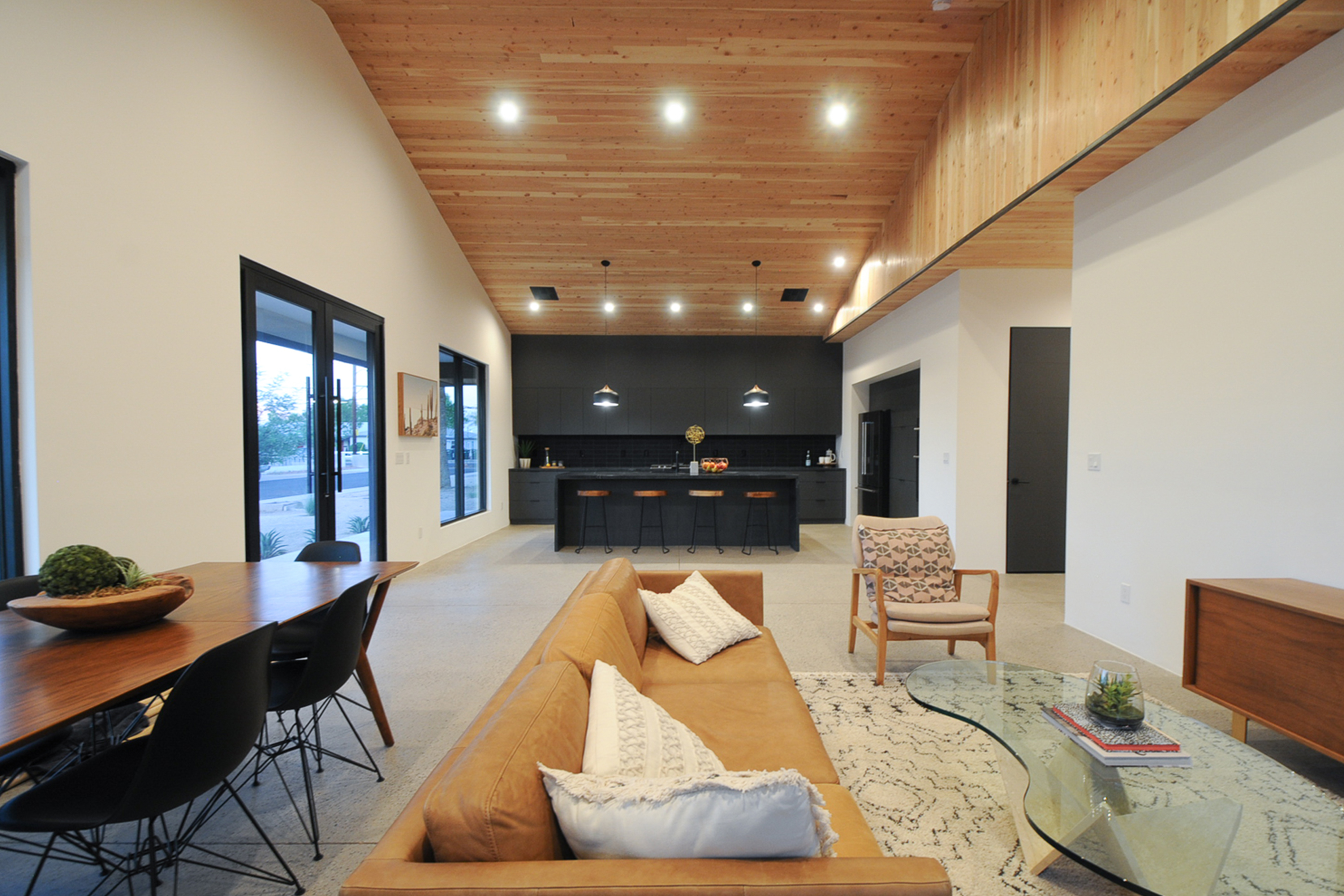 Open concept bali style home with wood clad vaulted ceilings